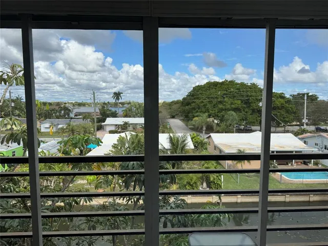 a view of a living room with furniture and a floor to ceiling window