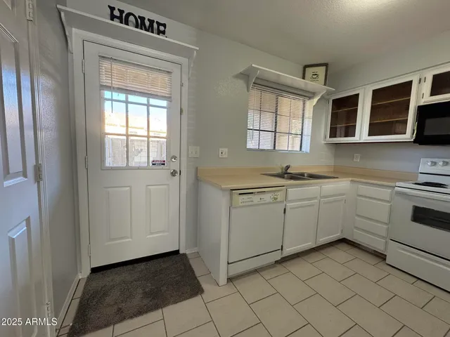 a kitchen with cabinets appliances and a sink