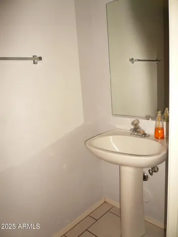 a bathroom with a sink and mirror