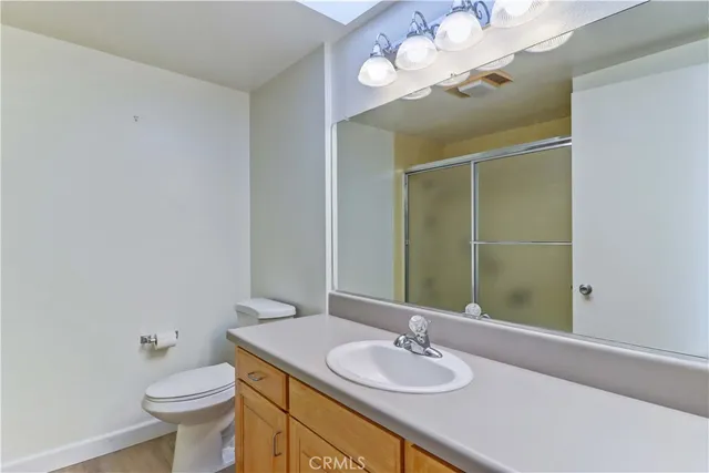 a bathroom with a glass shower door