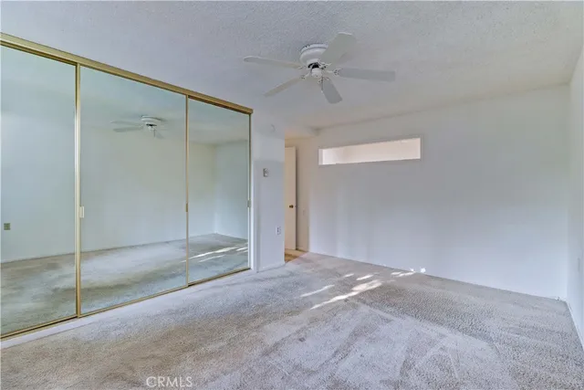 a bathroom with a granite countertop sink a toilet and a mirror