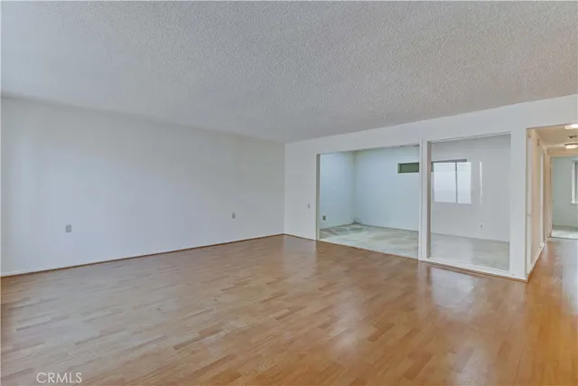 a view of an empty room and wooden floor