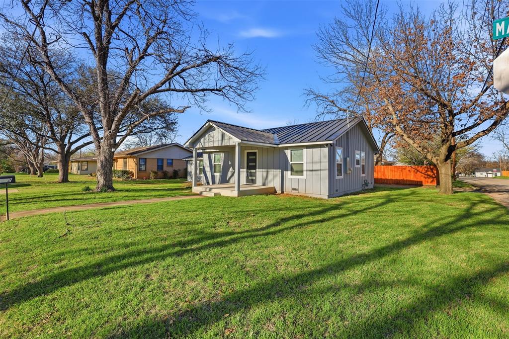 502 Madison Street Cleburne, TX 76033 - Photo 29 of 30 a front view of a house with a yard