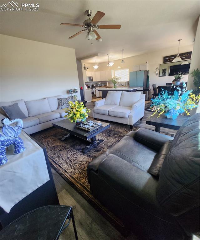 4530 Sierra Rica Road Colorado Springs, CO 80911 - Photo 11 of 44 a living room with furniture and a chandelier