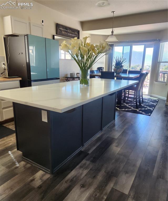 4530 Sierra Rica Road Colorado Springs, CO 80911 - Photo 28 of 44 a kitchen with stainless steel appliances granite countertop sink wooden floor dining table and chairs