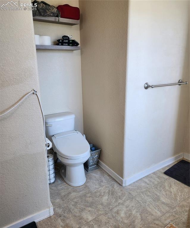 4530 Sierra Rica Road Colorado Springs, CO 80911 - Photo 31 of 44 a white toilet sitting next to a bathroom sink