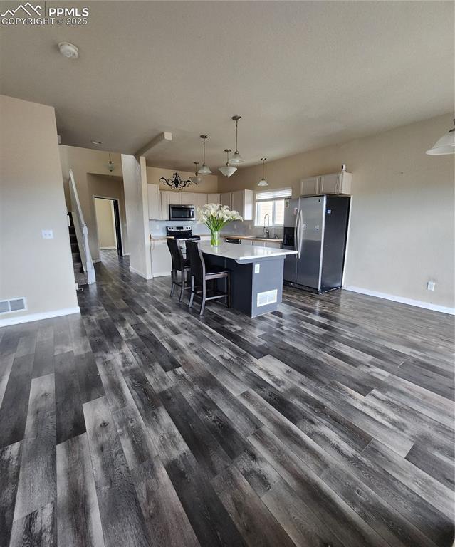 4530 Sierra Rica Road Colorado Springs, CO 80911 - Photo 41 of 44 a dining room with furniture a rug and wooden floor