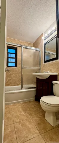 a bathroom with a toilet a sink and bathtub