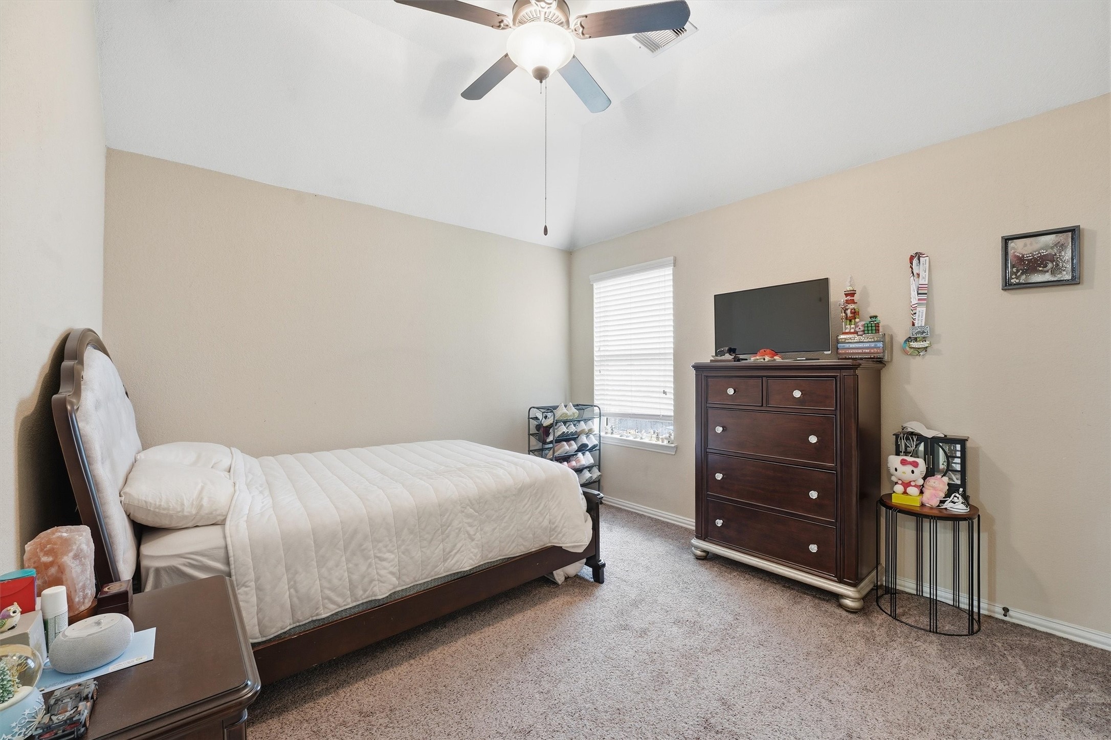 12506 Northpointe Ridge Lane Tomball, TX 77377 - Photo 24 of 31 a bedroom with a bed and a flat tv screen on a dresser