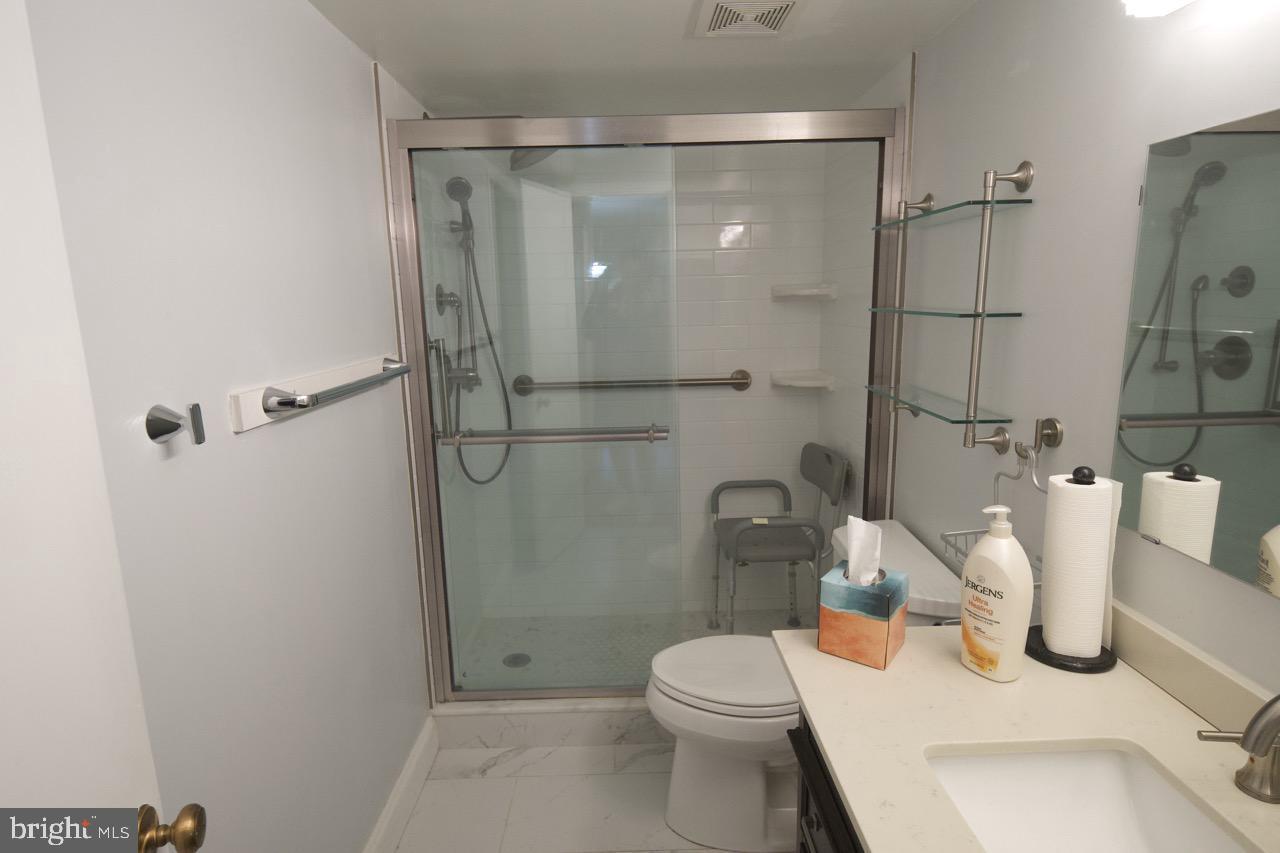 1800 Old Meadow Road, Unit 818 McLean, VA 22102 - Photo 16 of 35 a bathroom with a shower a toilet and sink