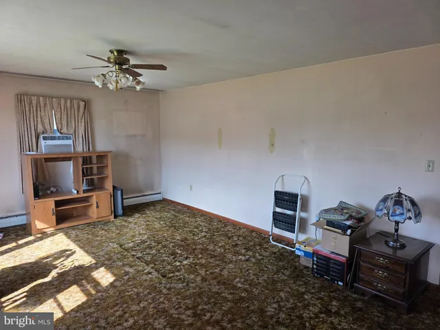 a bedroom with furniture and a flat screen tv