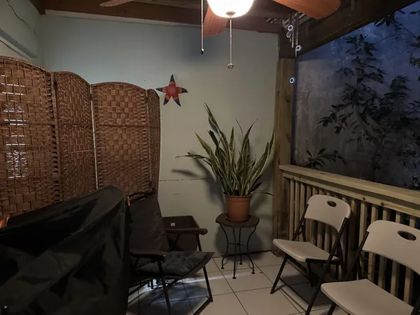 a view of balcony with furniture and potted plants