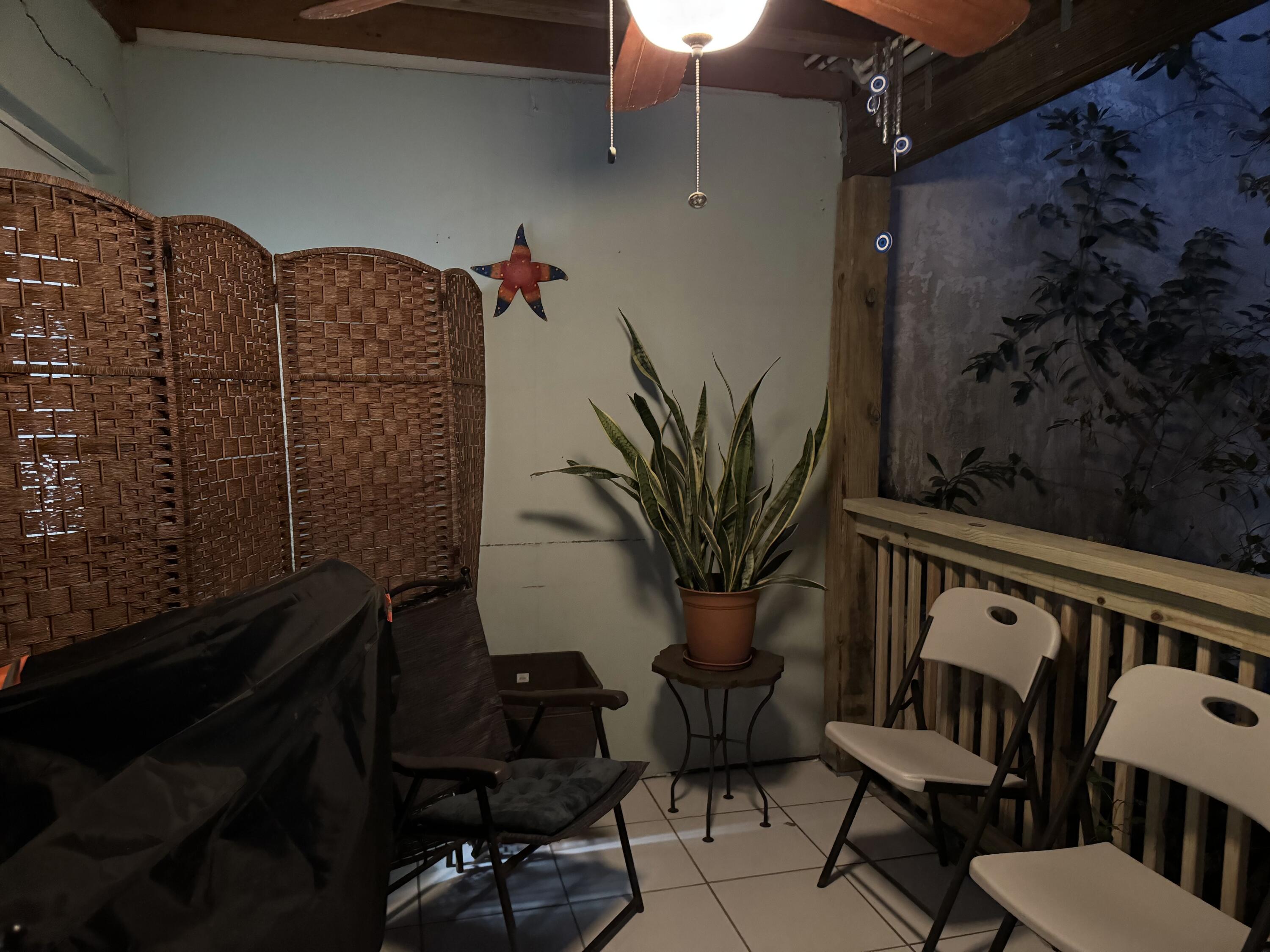 a view of balcony with furniture and potted plants