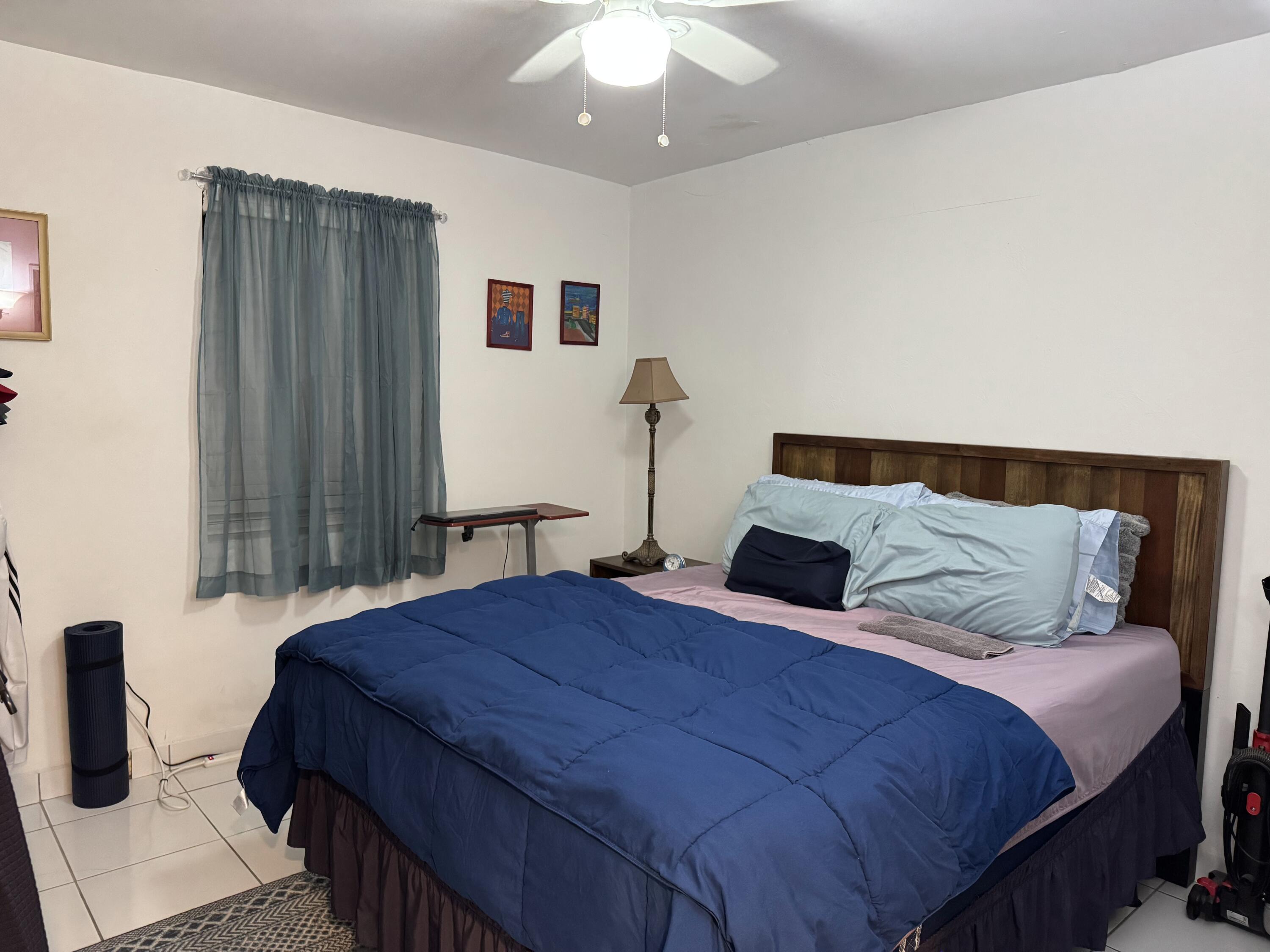 1612 Laird Street Key West, FL 33040 - Photo 16 of 18 a bedroom with a large bed and a chandelier