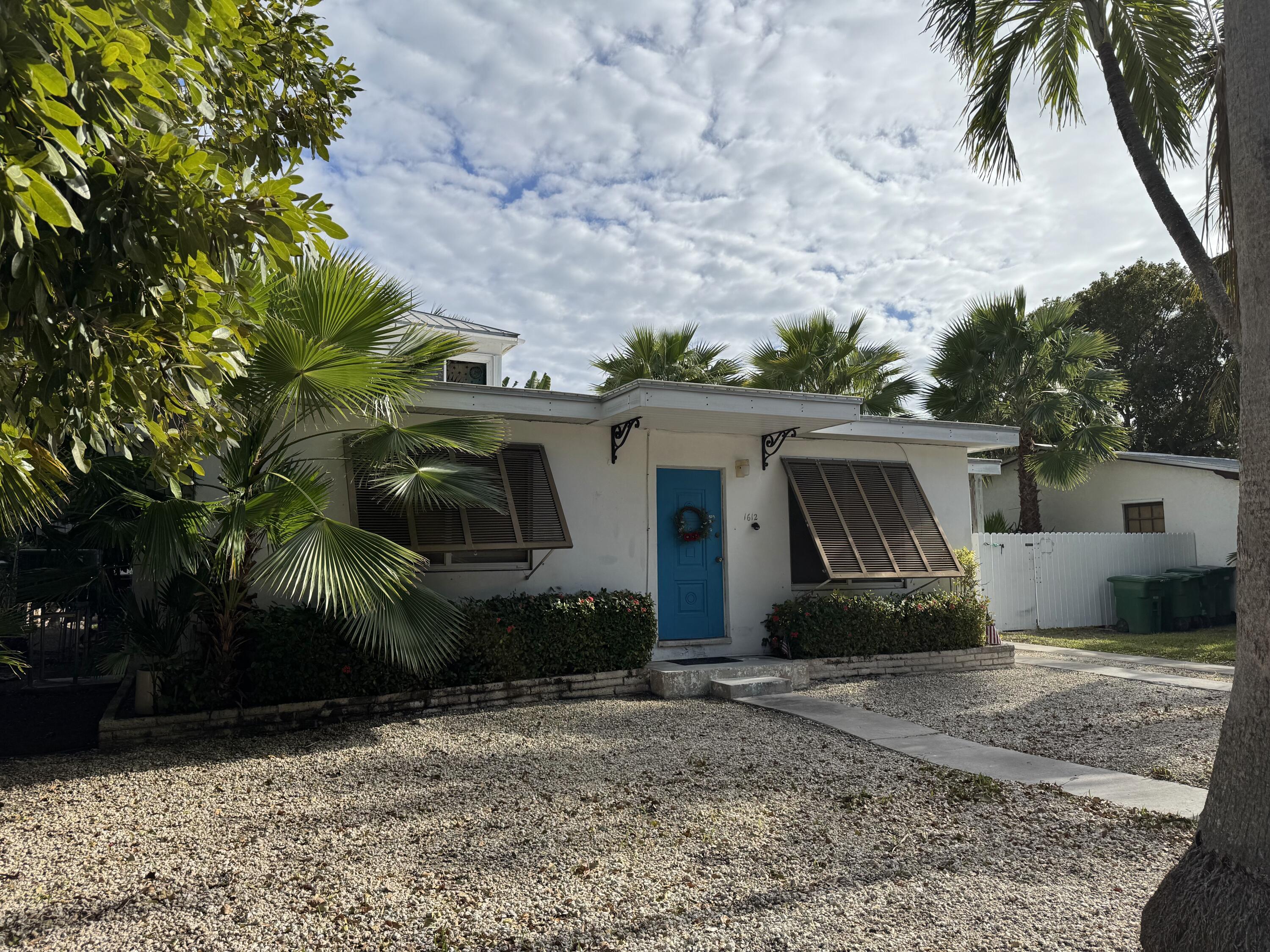 1612 Laird Street Key West, FL 33040 - Photo 4 of 18 a view of a barn in front of a yard with plants and trees