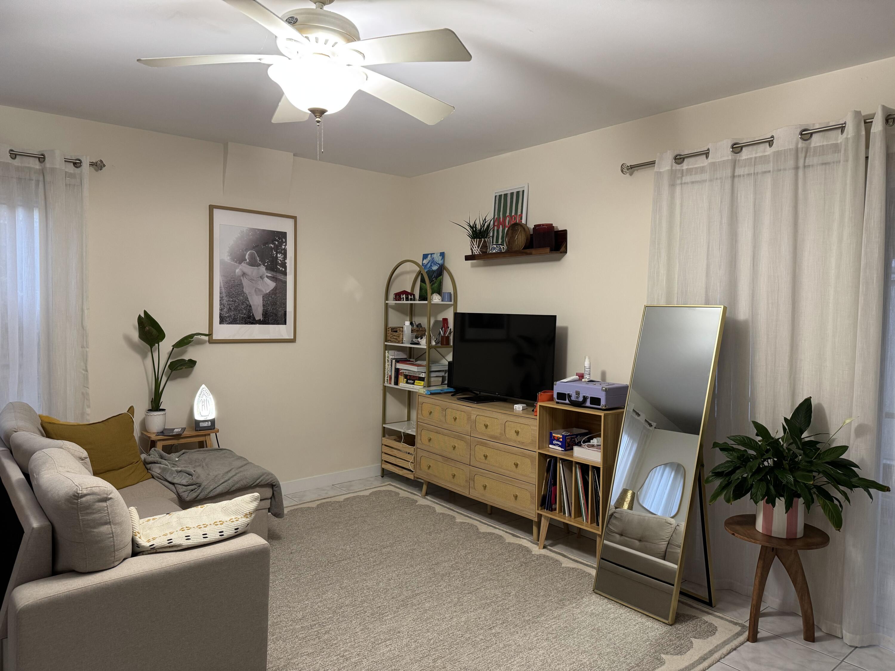 1612 Laird Street Key West, FL 33040 - Photo 7 of 18 a living room with furniture a flat screen tv and a potted plant