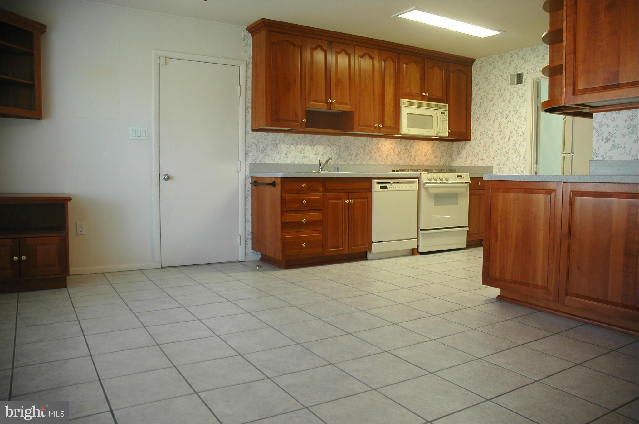 14717 Flintstone Lane Silver Spring, MD 20905 - Photo 2 of 26 a kitchen with a cabinets and window