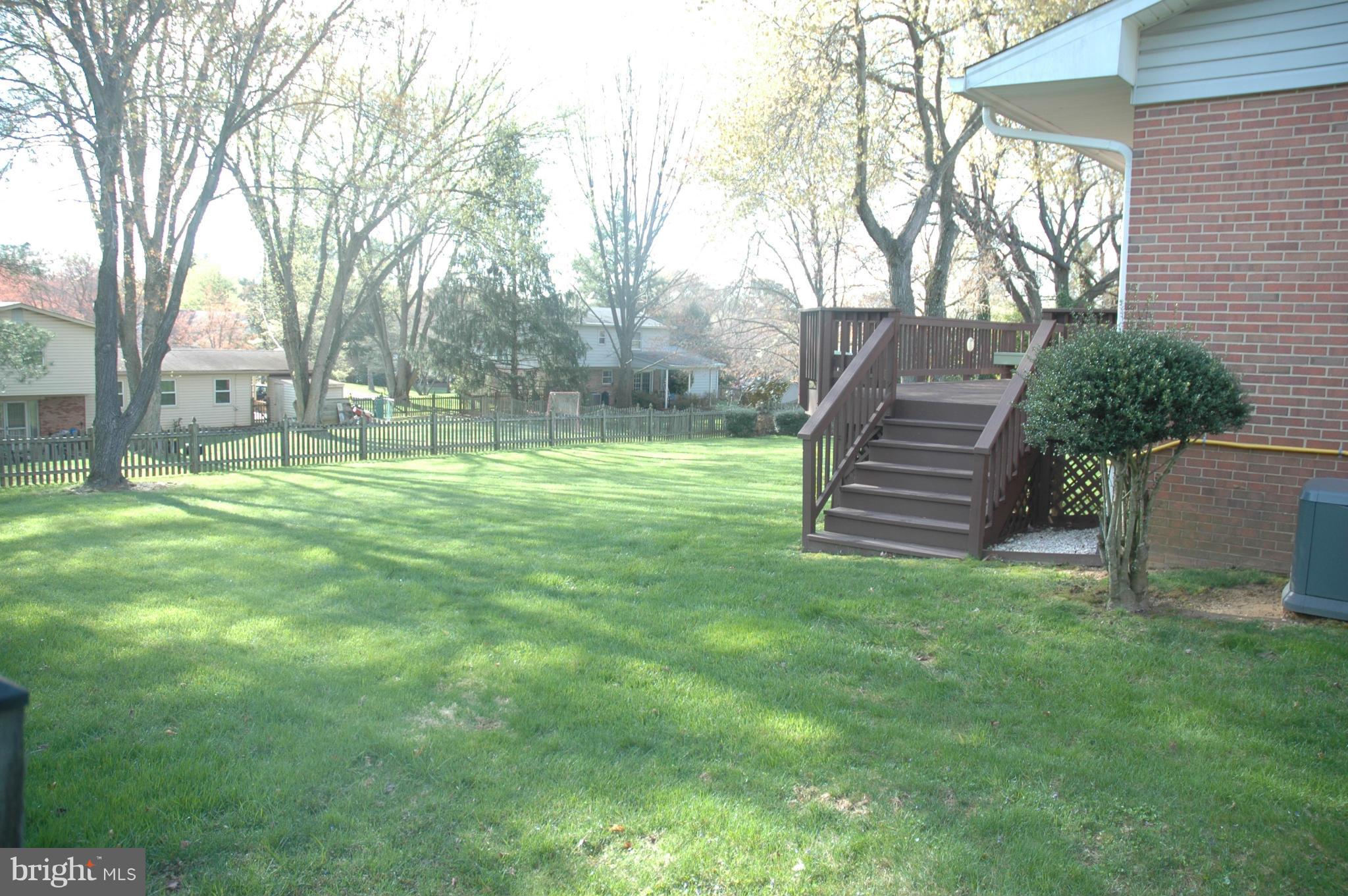 14717 Flintstone Lane Silver Spring, MD 20905 - Photo 11 of 26 a backyard of a house with lots of green space and fountain