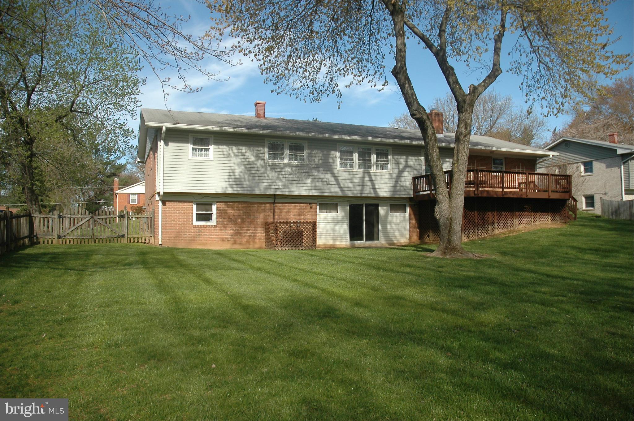 14717 Flintstone Lane Silver Spring, MD 20905 - Photo 17 of 26 a view of a big house with a big yard and large trees