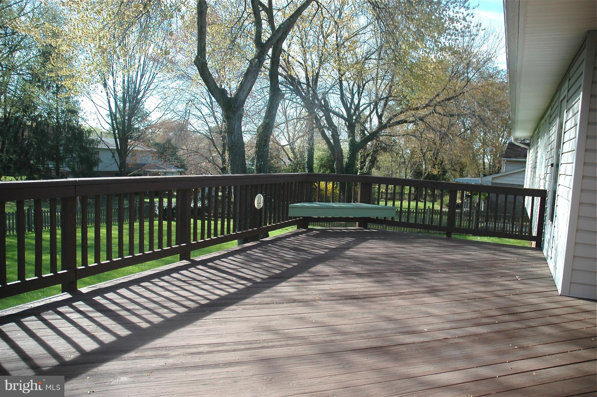 14717 Flintstone Lane Silver Spring, MD 20905 - Photo 19 of 26 a view of a deck with large trees and wooden fence