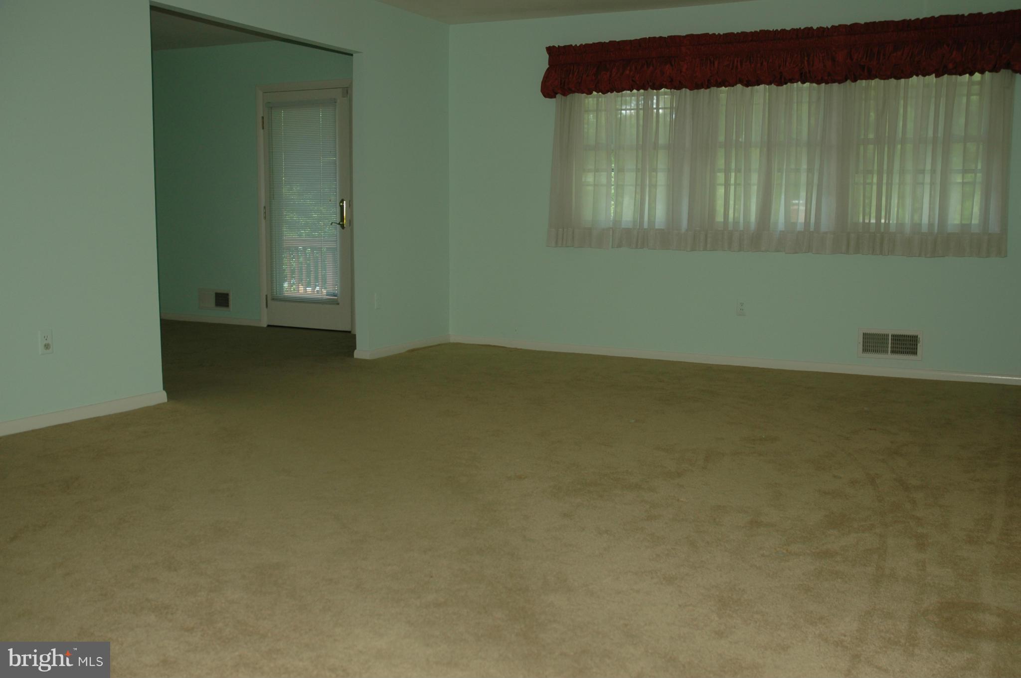14717 Flintstone Lane Silver Spring, MD 20905 - Photo 25 of 26 an empty room with a fireplace