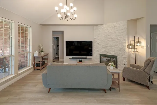 a living room with furniture a fireplace and a flat screen tv