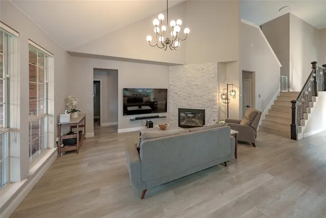 a living room with furniture a flat screen tv and a fireplace