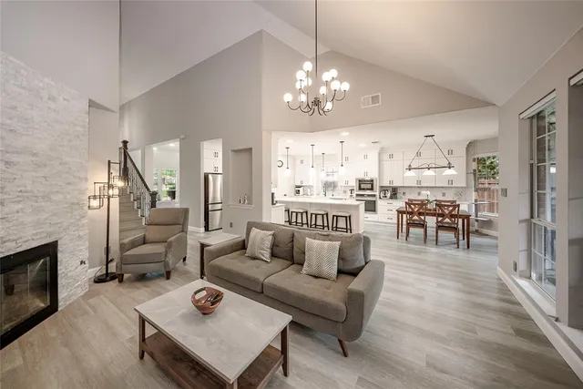 a living room with furniture and a chandelier