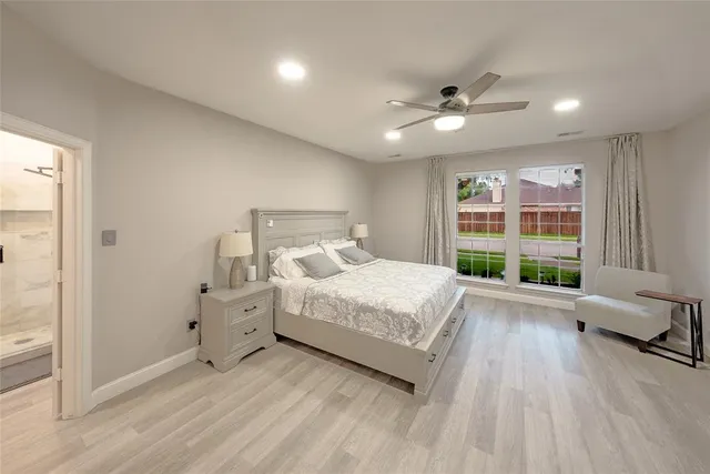 a spacious bedroom with a bed and a large window