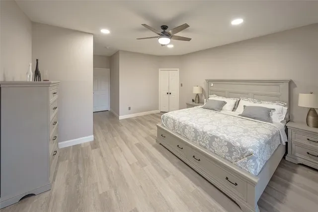 a bedroom with a bed and a ceiling fan