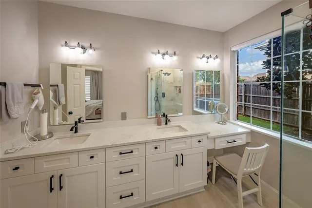 a bathroom with a double vanity sink and a mirror