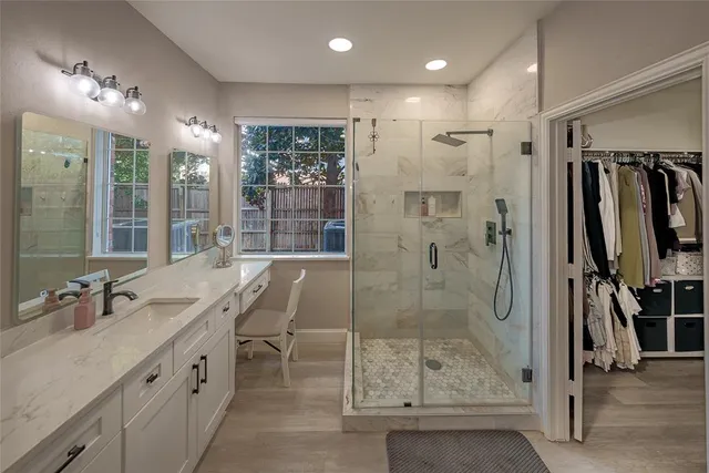 a bathroom with a shower sink and mirror