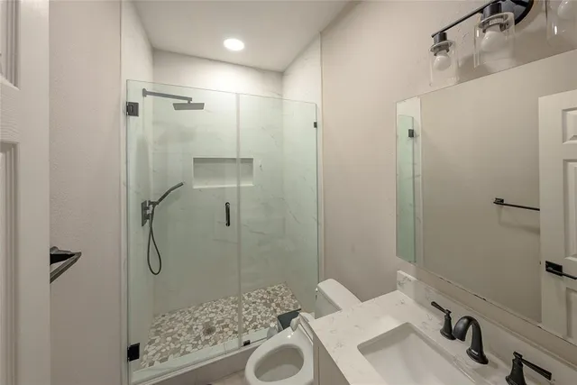 a bathroom with a sink and shower