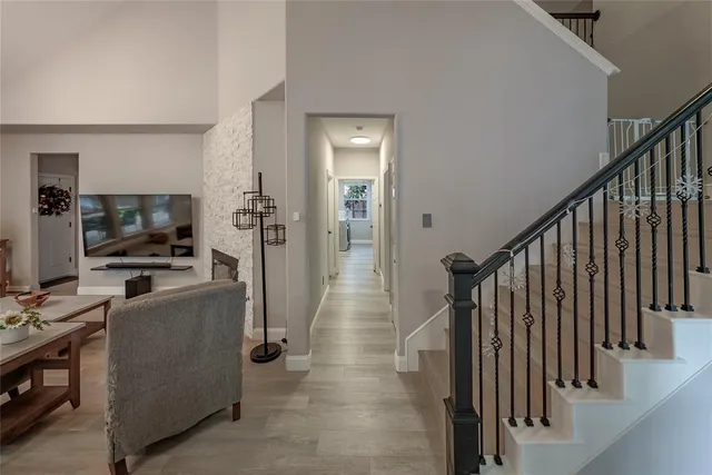 a view of a hallway with workspace and living room