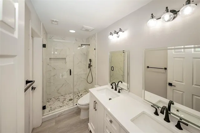 a bathroom with a double vanity sink mirror double shower and a bathtub