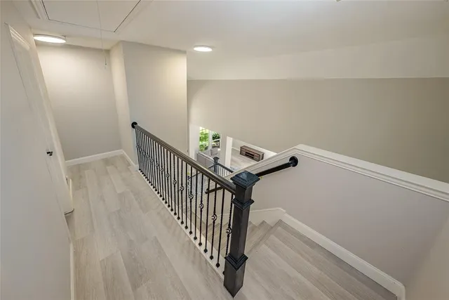 a view of a hallway with wooden floor
