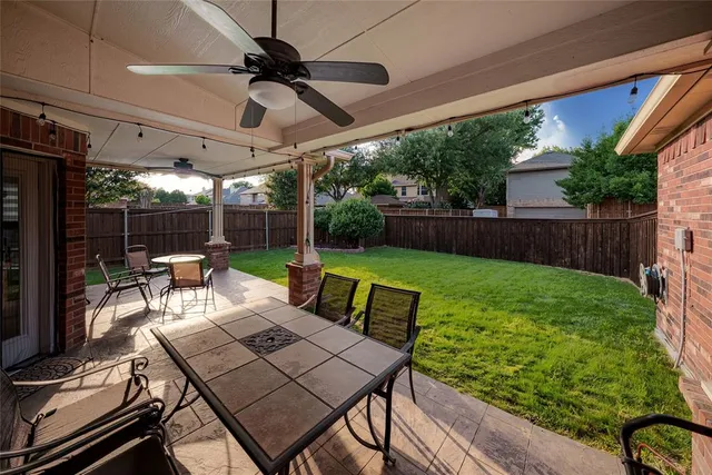 a view of yard with patio