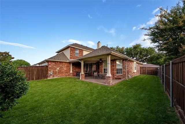 a view of a house with a yard and deck