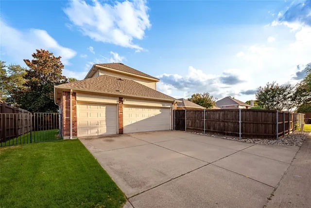 a view of a front of a house with a yard and fence
