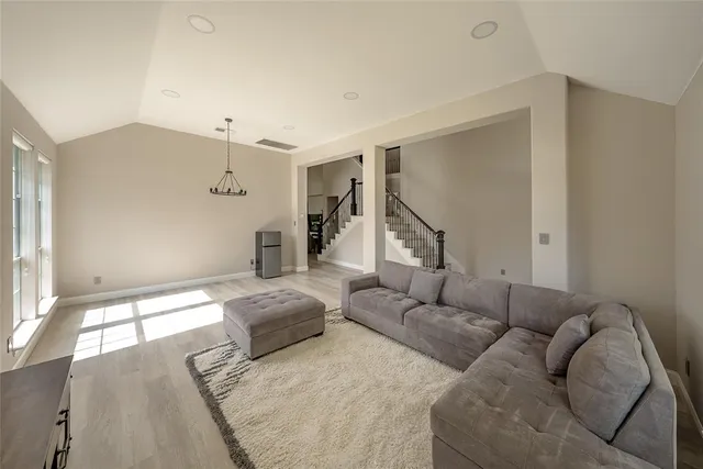 a living room with furniture and a ceiling fan