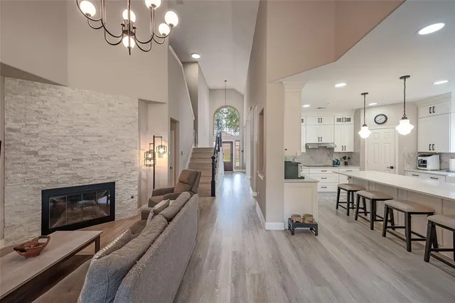 a large kitchen with a table chairs refrigerator and cabinets