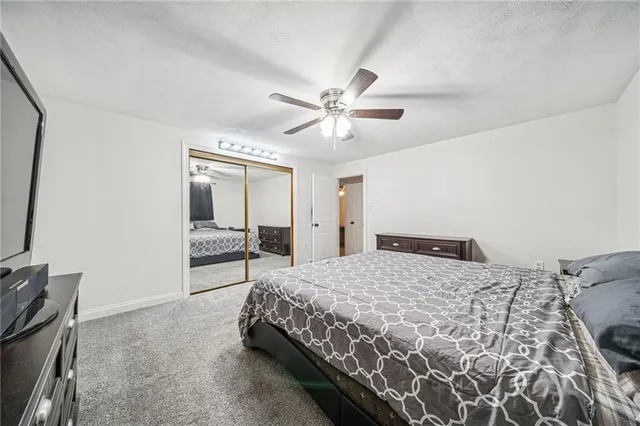 a spacious bedroom with a bed and a chandelier