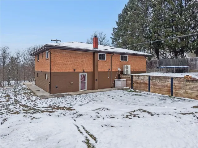 a view of a house with a wooden fence