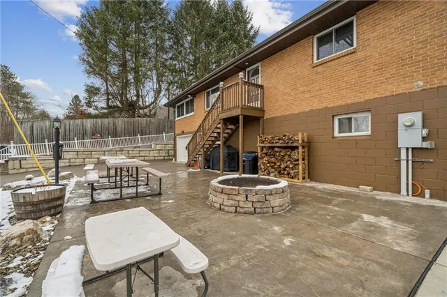 a backyard of a house with a fountain table and chairs