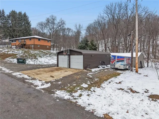 a view of a house with a snow in the yard