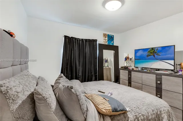 a bed room with a bed and a television