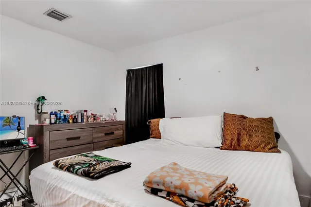 a bedroom with a bed and a dresser