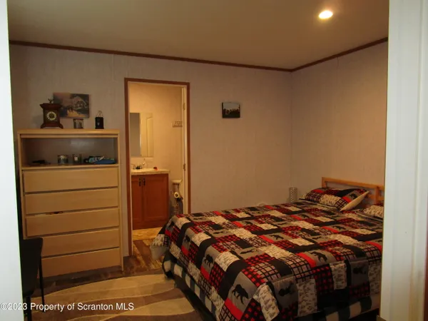 a bed sitting in a bedroom next to a cabinet