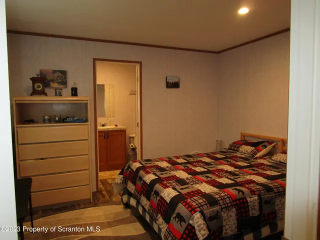 a bed sitting in a bedroom next to a cabinet