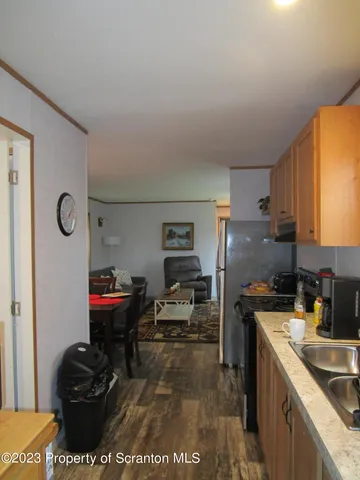 a kitchen with refrigerator and cabinets